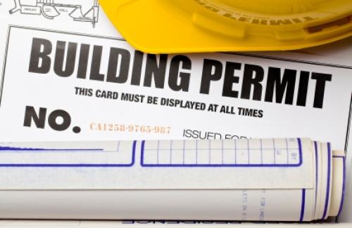 pic of building permit with yellow construction hat