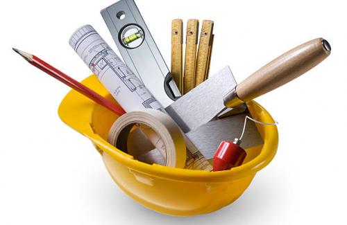 builder tools in a yellow construction hat