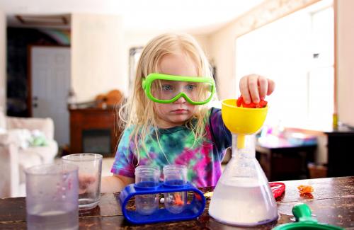 Kid playing with science equipment