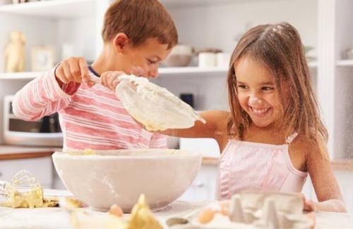 Kids playing with flour in the kitchen